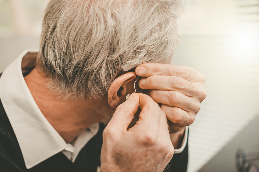 Man putting hearing aids Can Hearing Problems Affect Your Loved One's Quality Of Life?