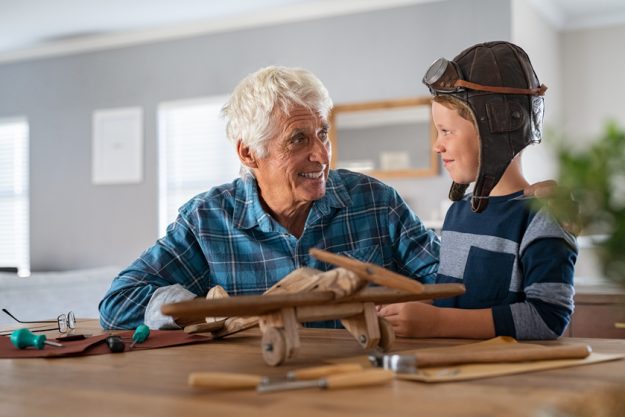 Happy grandfather build a wooden airplane with his grandson Happy grandfather build a wooden airplane with his grandson