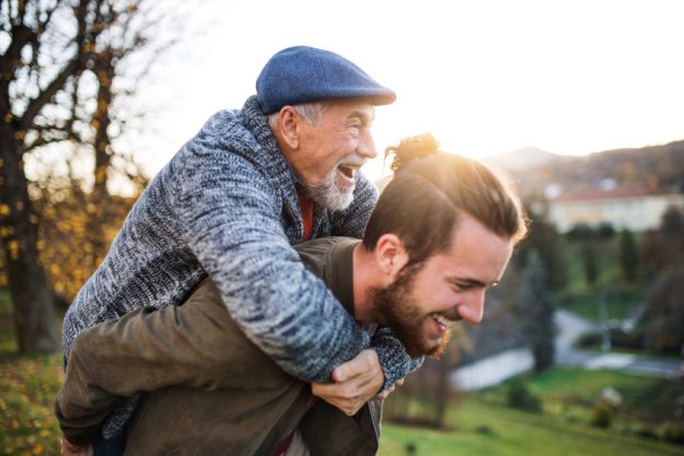 Senior father and his son walking in nature, having fun. Fun Activities To Celebrate Father's Day With Your Loved One In Assisted Living