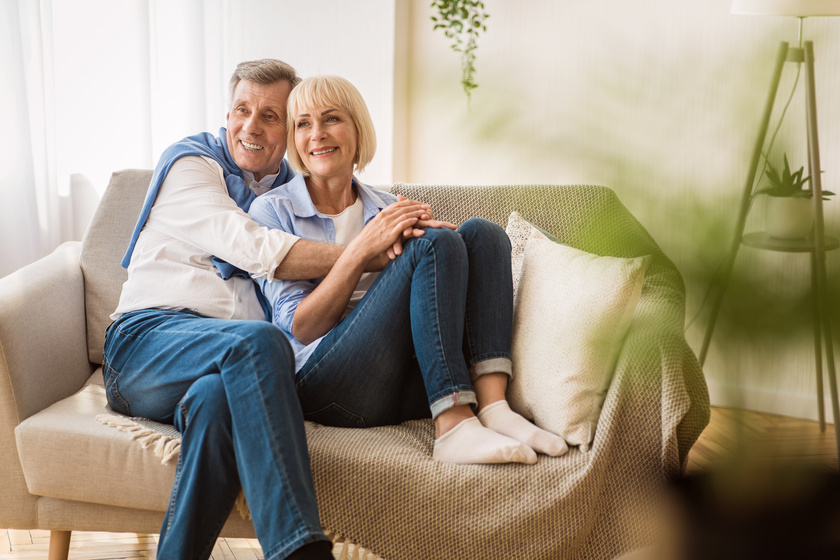 Romantic senior couple sitting close together on sofa How To Help Decorate Your Loved One’s Assisted Living Apartments
