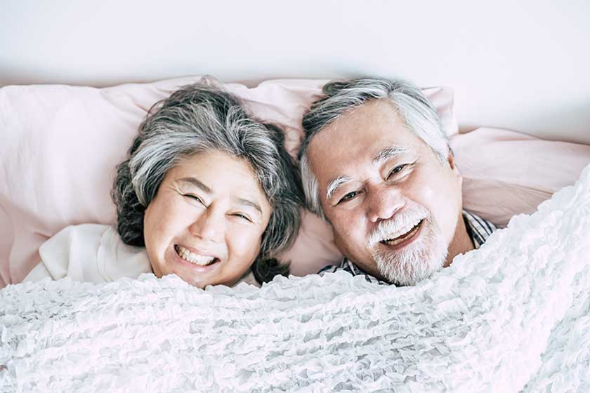 Senior couple lying in bed together