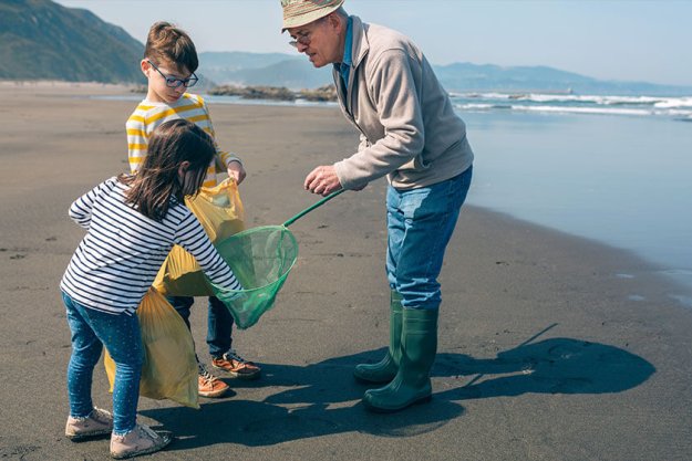 Grandfather and grandchildren taking garbage