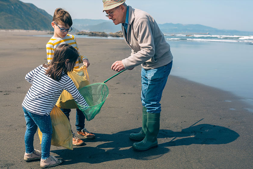 Grandfather and grandchildren taking garbage