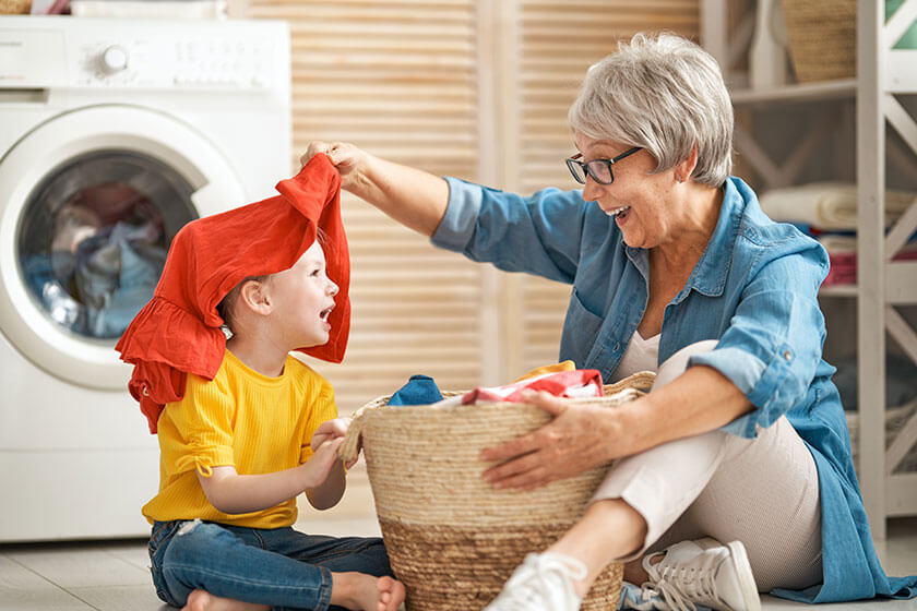 grandma and child are doing laundry