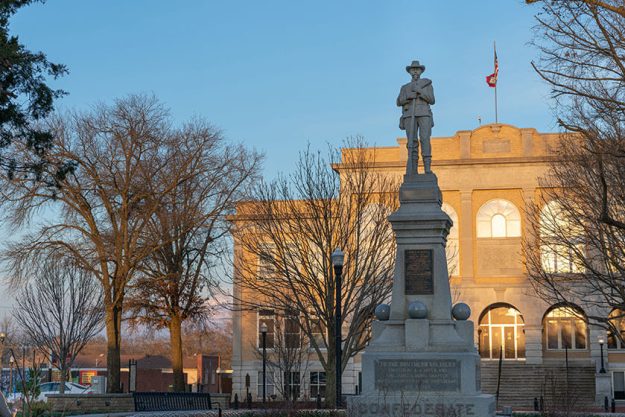 Statue of confederate soldier James H Berry, southern soldiers, USA Arkansas flags