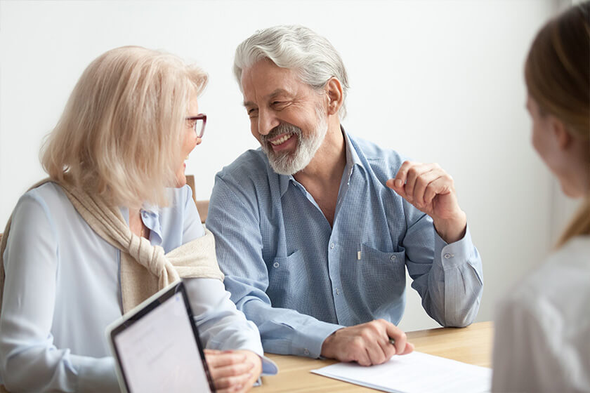 Happy senior family talking smiling at meeting with financial advisor