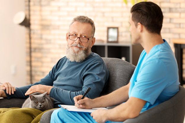 Caregiver with senior man at home