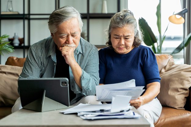 old retired asian senior couple checking and calculate financial billing together old retired asian senior couple checking and calculate financial billing together