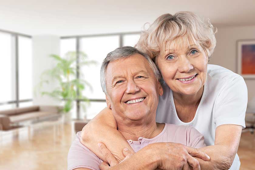 Close-up portrait of an elderly couple hugging in park Close-up portrait of an elderly couple hugging in park