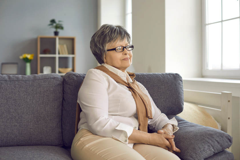 Portrait of happy retired mature woman sitting on couch at home and looking away Never Make These Mistakes When Searching For Independent Living