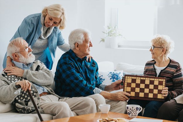 Senior friends sit on the sofa in the living room Senior friends sit on the sofa in the living room