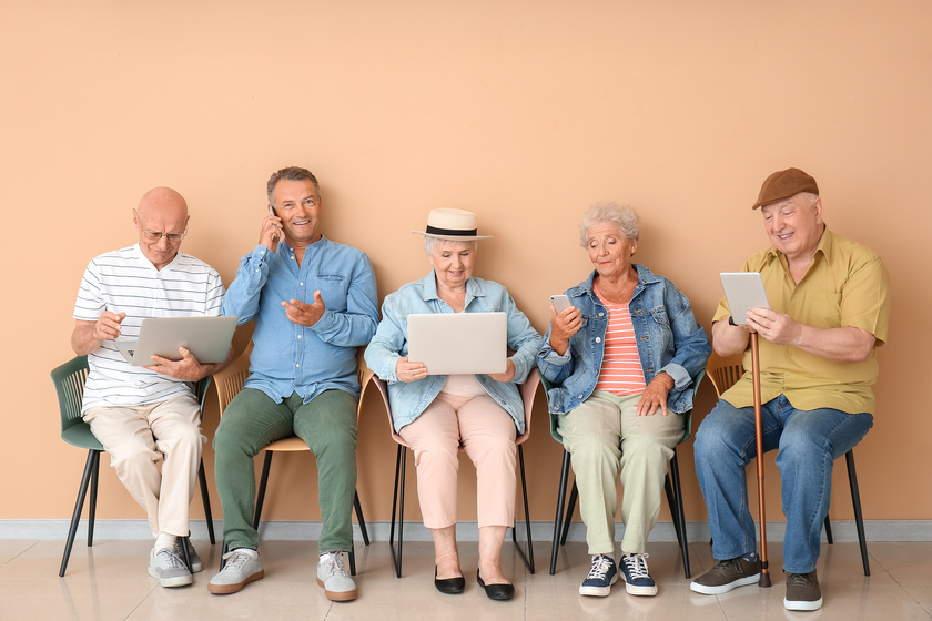 Senior people with different devices sitting on chairs in room What To Know About Texas Continuing Care Retirement Community