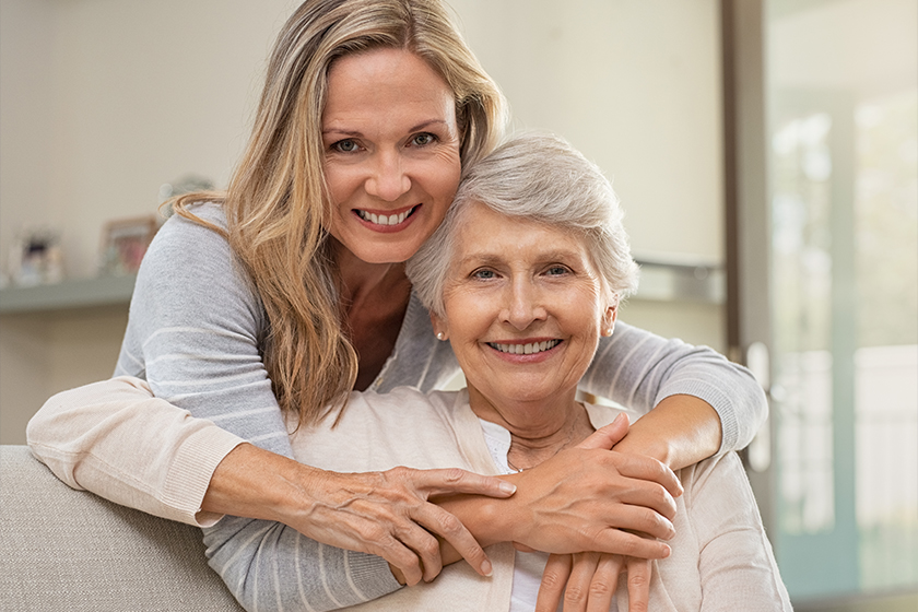 Woman hugging mother with love Woman hugging mother with love