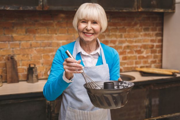 Portrait of attractive smiling happy senior aged woman is cookin Portrait of attractive smiling happy senior aged woman is cookin