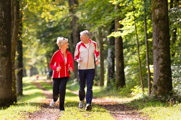 Seniors jogging on a forest road How Living In Sardis, TX Senior Living Communities Can Increase Your Life Expectancy