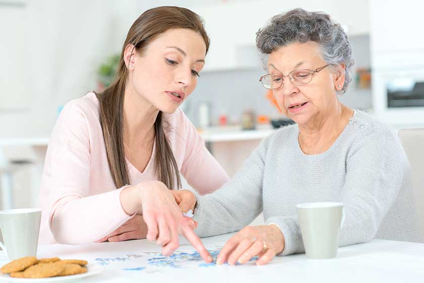 Old lady doing a jigsaw puzzle Old lady doing a jigsaw puzzle