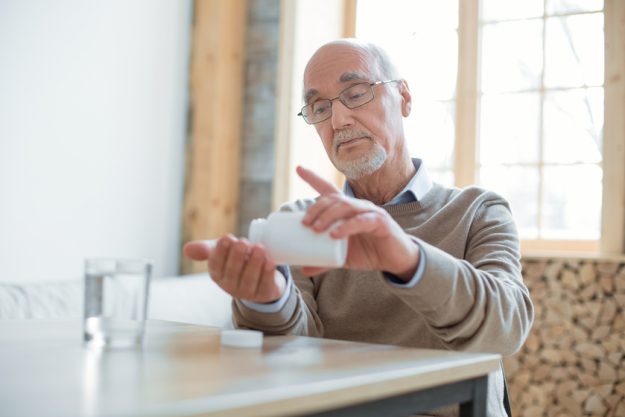 Earnest senior man taking medication The Importance Of Proper Medication Management For Someone Your Age