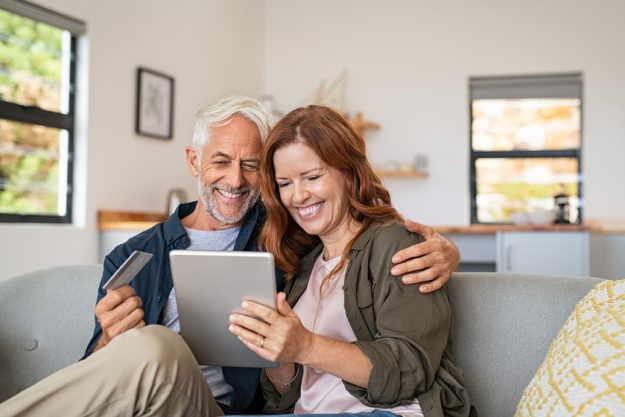 Mature couple doing online shopping with digital tablet Mature couple doing online shopping with digital tablet