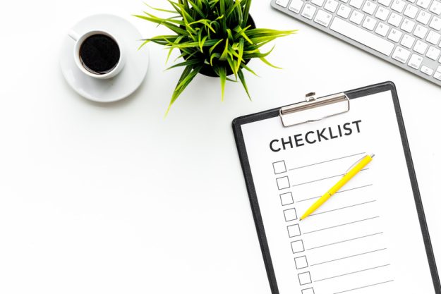 Blank checklist with space for ticks on pad on office desk. Checklist for office worker, manager, businessman, chief on white background top view space for text