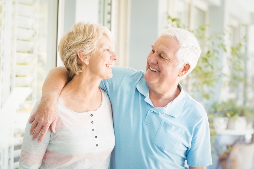 Smiling romantic senior couple at home