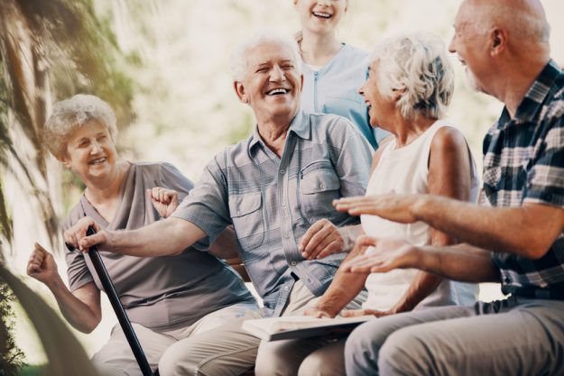 Happy elderly man with walking stick and smiling senior people r Happy elderly man with walking stick and smiling senior people r
