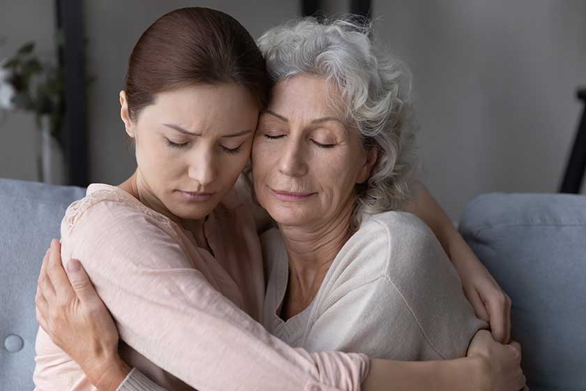 Caring millennial woman child embrace unhappy upset old 60s mother show love and care.