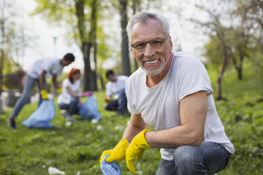 Pleasant senior volunteer getting rid of trash Active Senior's Guide To Volunteering In Arlington, Texas