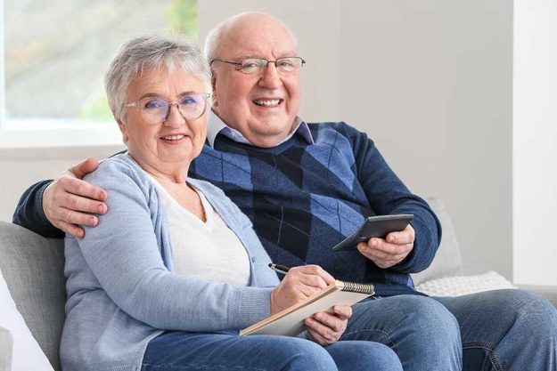 Senior couple calculating expenses at home