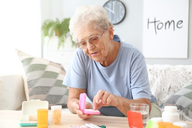 Elderly woman with medicines at home 5 Common Medication Errors & How Assisted Living Communities Can Help