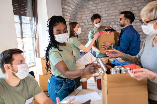 Group of volunteers with face mask working in community charity Active Retirement Community In Arlington, TX: Where To Find Trusted Volunteer Organizations