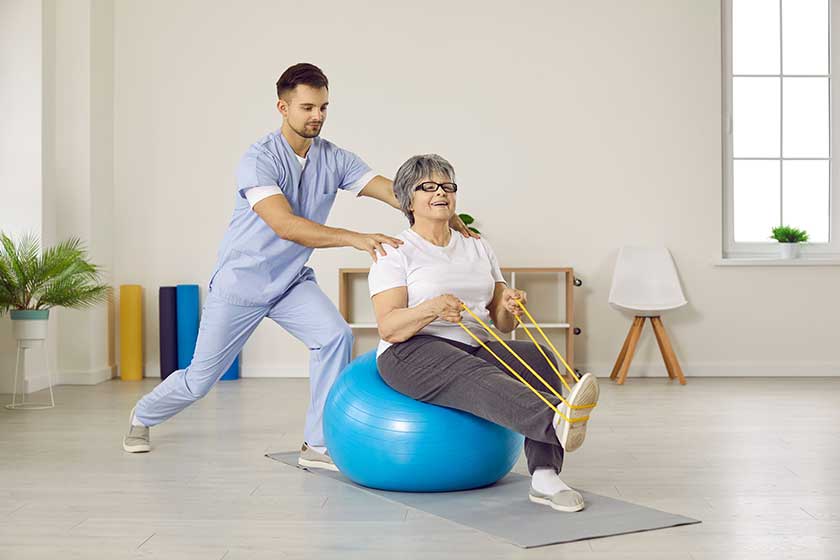 Male physiotherapist do exercises workout with elderly woman patient in physio medical clinic Male physiotherapist do exercises workout with elderly woman patient in physio medical clinic