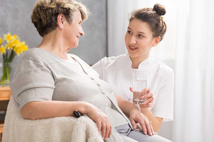Elderly woman and glass of water