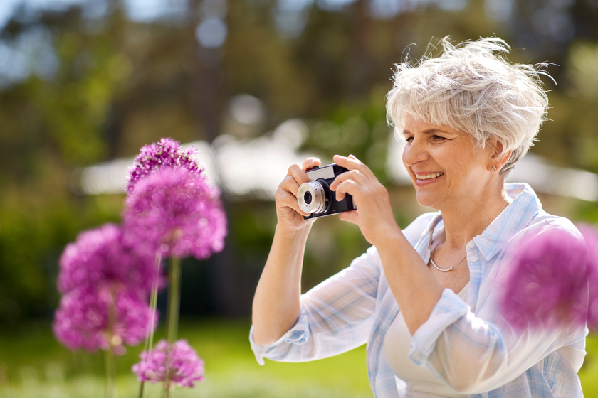 senior woman with camera photographing flowers Enjoying Your Life In A Retirement Community In Arlington, TX: Why You Should Consider Photography
