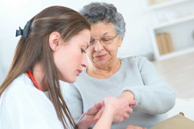 Female doctor with older patient