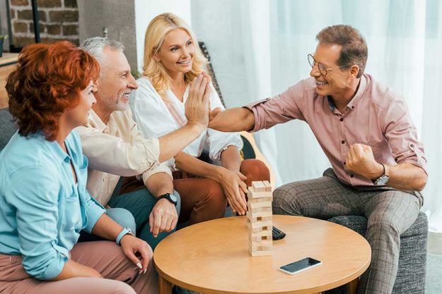 Happy mature men giving high five