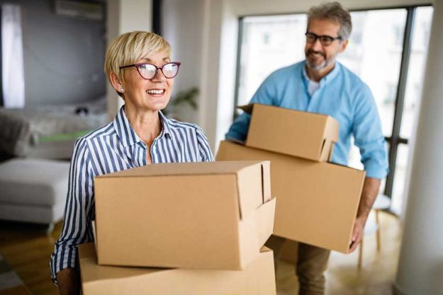 Happy retired senior couple in love moving into a new home
