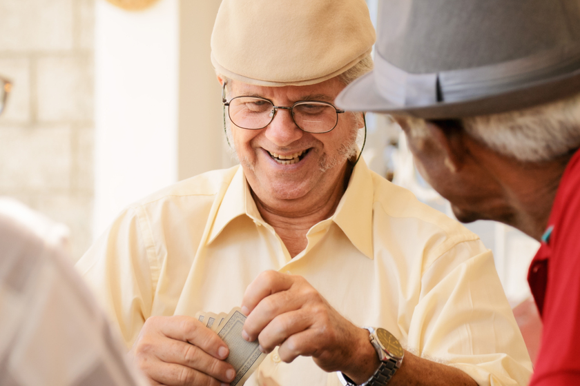 Group Of Happy Seniors Playing Cards Game How Can A Friendly Environment For Dementia Make Patients Feel More At Ease
