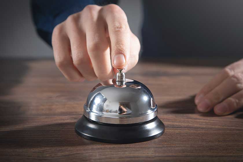 Male hand ringing in service bell