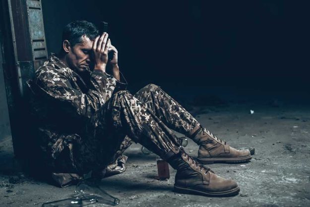 Man Is Sitting In War Shelter With Shotgun Man Is Sitting In War Shelter With Shotgun