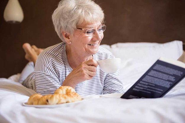 Mature woman reading in bed