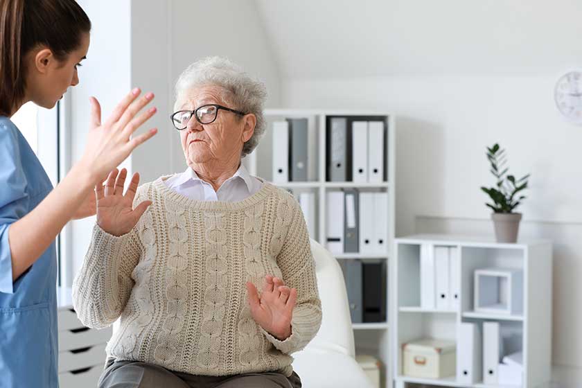 Medical worker mistreating senior woman Medical worker mistreating senior woman