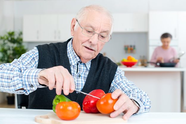 old man preparing the tomatoes