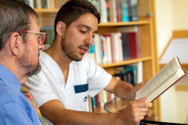 Senior Man Listening Reading Male Nurse Senior Man Listening Reading Male Nurse