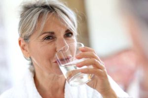 Senior woman drinking water