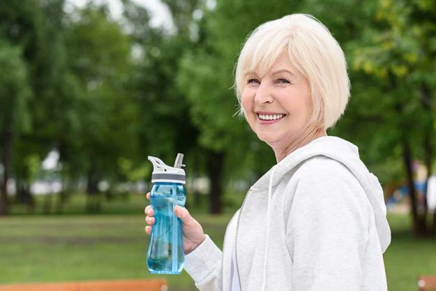Senior woman holding sport bottle