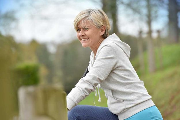 Senior woman stretching after exercising