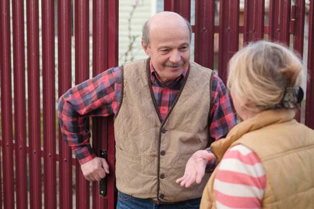 Two senior neighbors takling to each other Two senior neighbors takling to each other
