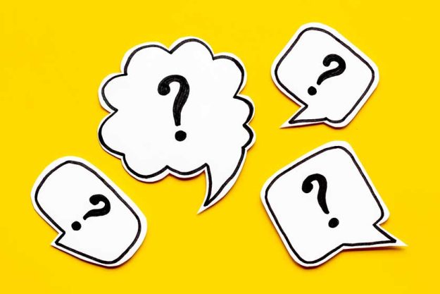 Ask question concept. Question mark on speech bubbles, top view