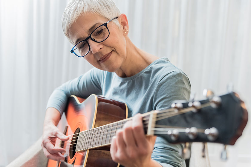 Cheerful Charming Beautiful Mature Woman Enjoy Playing Guitar