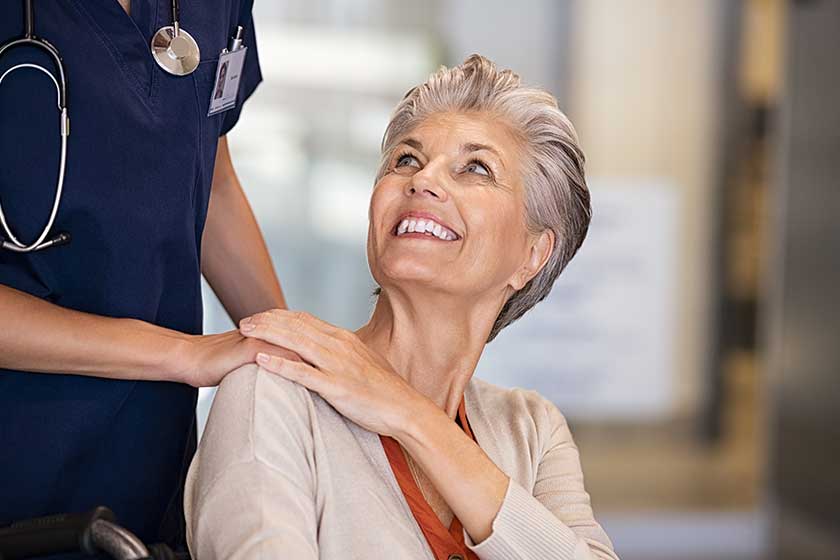 Caring nurse comforting old woman Caring nurse comforting old woman